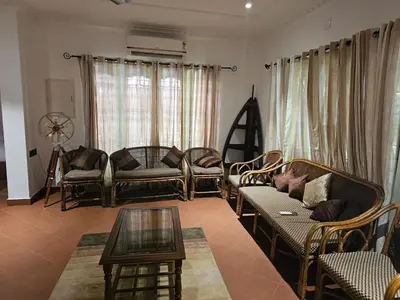 a living room with a couch and chairs and a table at The Isle By Area 707 in Alwaye