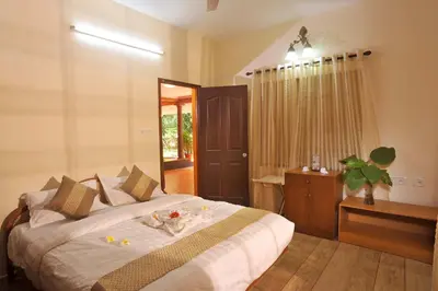 a bedroom with a large bed and a window at The Isle By Area 707 in Alwaye