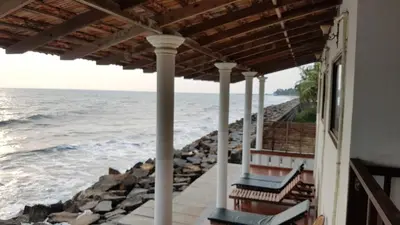 a view of the ocean from the porch of a house at Cherai Onetree Retreat in Cherai Beach