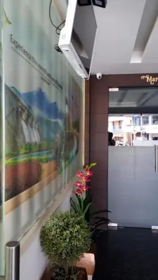 a lobby with a painting of a train on the wall at Nalanda Inn in Palakkad