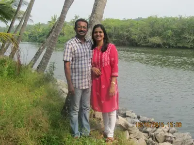 a man and a woman standing next to a river at KK Heritage in Kannur