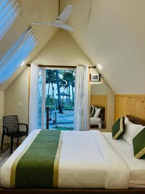 a bedroom with a large bed and a window at Veda5 Ayurveda Living Village in Trichūr