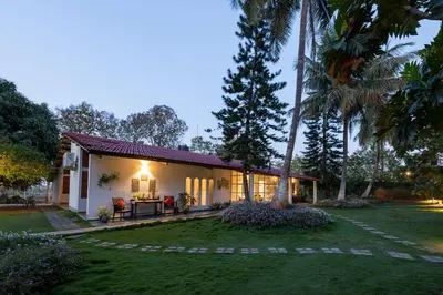 a villa with a garden and a house at The Mangifera in Bandipūr