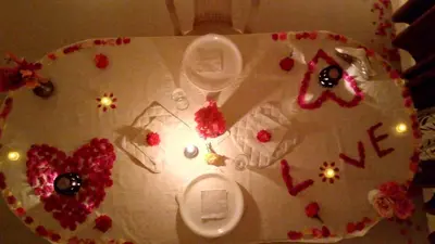 a white table with flowers and a sign that says love at Skylarc Inn in Ooty