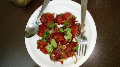 a plate of food on a table with a fork and knife at Skylarc Inn in Ooty