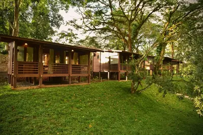 a house in the middle of a green yard at Sirukundra Garden Bungalow in Vālpārai