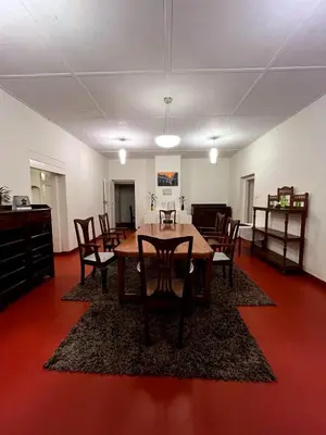a dining room with a table and chairs at Sirukundra Garden Bungalow in Vālpārai