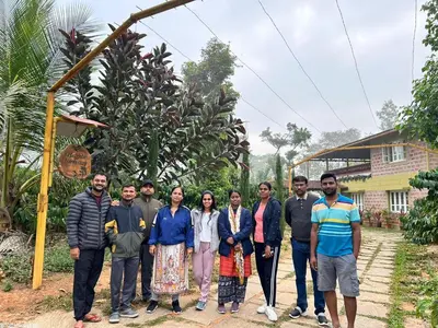 a group of people posing for a picture in front of a house at Heights Farm Stay - Coffee Estate Stay in Madikeri