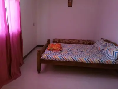a small bedroom with a bed with a tray on it at Hill side estate in Madikeri