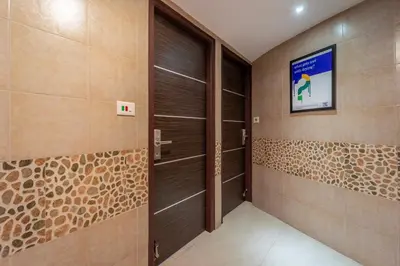 a hallway with a door and a tv on the wall at Treebo Venition Inn in Coimbatore