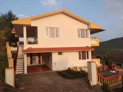 a house with a view of the front of it at Mist Resorts Ooty in Ooty
