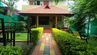 a house with a pathway leading to the front door at Silent Wild in Masinagudi