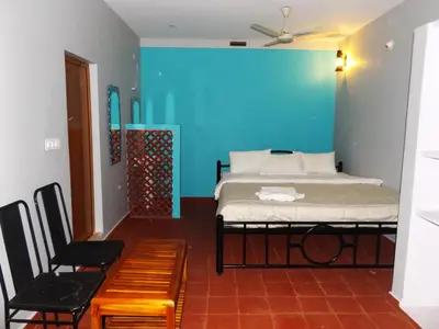 a bedroom with a bed and a blue wall at Silent Wild in Masinagudi