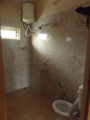 a bathroom with a toilet and a sink at Silent Wild in Masinagudi