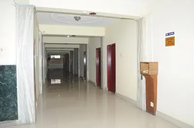 an empty hallway in a building with a hallway at Hotel Chanma International in Coimbatore