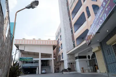 a street view of a building with a parking garage at Hotel Chanma International in Coimbatore