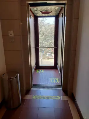 an open door to a bathroom with a window at Issacs Residency in Munnar