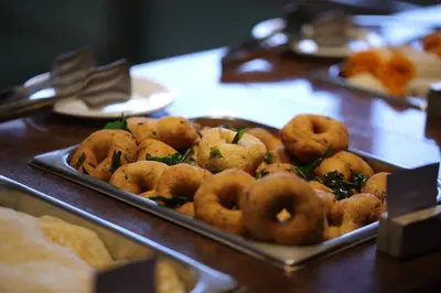 a tray of donuts sitting on a table at Issacs Residency in Munnar