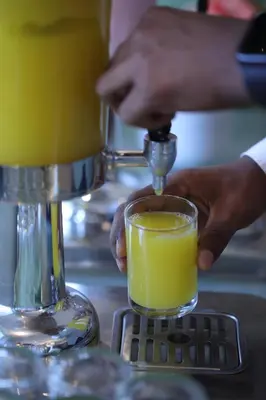 a person is making a drink in a mixer at Issacs Residency in Munnar