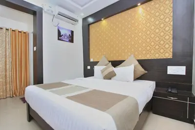 a bedroom with a large bed in a room at Aishwarya Le Royal in Mysore