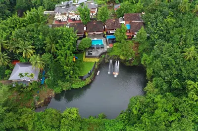 an aerial view of a house in the middle of a river at Athirapally Green Trees in Athirappilly
