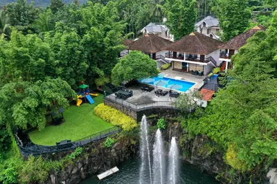 an aerial view of a house with a waterfall at Athirapally Green Trees in Athirappilly