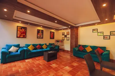 a living room with two blue couches and a table at Athirapally Green Trees in Athirappilly