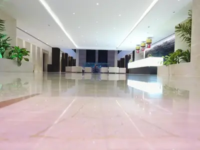 an empty lobby with plants in a building at M Inn in Coimbatore
