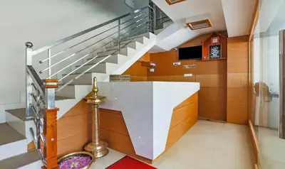 a staircase in a house with a stair case at Itsy Hotels Kottaram Residency, 10 Mins To Botanical Garden in Ooty