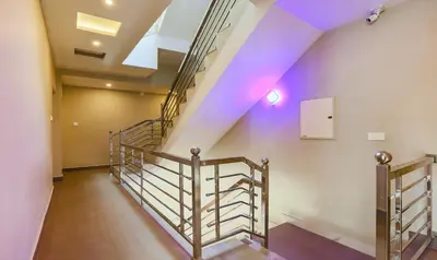 a staircase in a building with purple lighting at Itsy Hotels Kottaram Residency, 10 Mins To Botanical Garden in Ooty