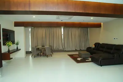 a living room with a couch and a table at Vavas Inn & Suites in Perintalmanna