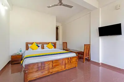 a bedroom with a bed and a flat screen tv at Itsy Hotels Jammabane Cottage, 5 Minutes To Mountain View Coffee Plantation in Madikeri
