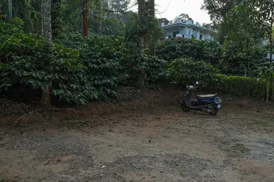 a motor scooter parked in front of a house at Itsy Hotels Jammabane Cottage, 5 Minutes To Mountain View Coffee Plantation in Madikeri