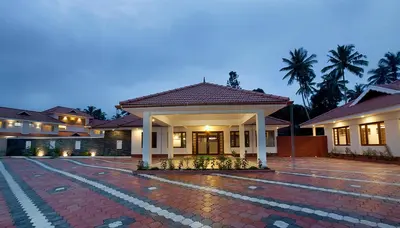 a house with a brick driveway in front of it at Le Coffee Resort in Sultan Bathery