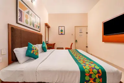 a bedroom with a large bed with green pillows at Treebo Sam Residency in Coimbatore