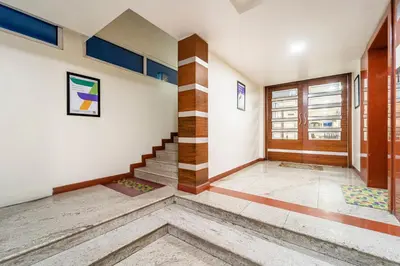 an empty room with a staircase in a house at Treebo Sam Residency in Coimbatore