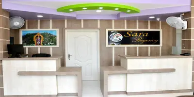 a restaurant with a santa destroy sign on the wall at Sara Regency in Palani