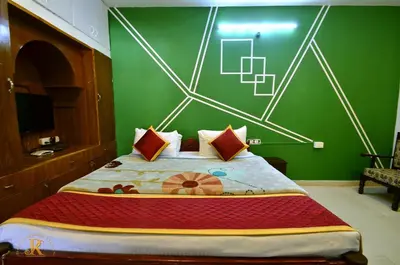 a bedroom with a large bed with a green wall at Royal Serene Villas in Ooty