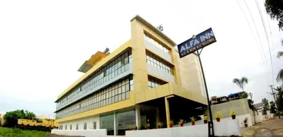 a building with a street sign in front of it at Alfa Inn in Nedumbassery