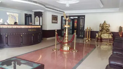 a lobby with gold items on the floor of a building at Hotel Horizon International in Guruvāyūr