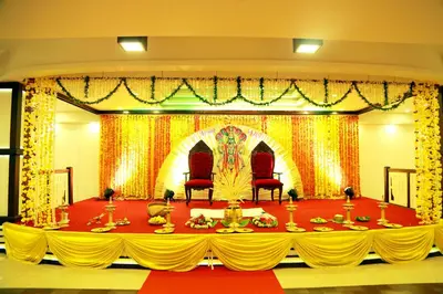 a banquet hall with a table with yellow and red decorations at Hotel Horizon International in Guruvāyūr