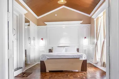 a bedroom with a bed with a wooden ceiling at Pine View Stay Ooty in Ooty