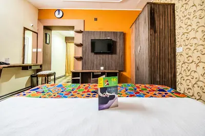 a hotel room with a bed and a tv at Via St Clouds - Nr Government Botanical Garden in Ooty