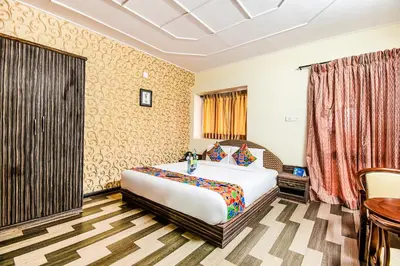 a hotel room with a bed and a table at Via St Clouds - Nr Government Botanical Garden in Ooty