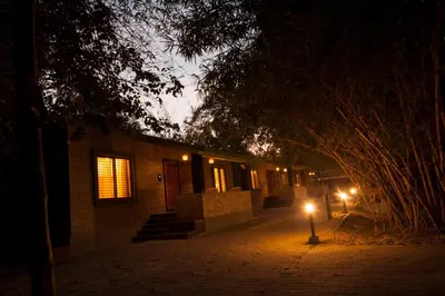 a building with a street light in front of it at night at MC Resort Wildlife Resort Bandipur in Bandipūr