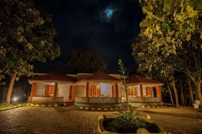 a house at night with the lights on at MC Resort Wildlife Resort Bandipur in Bandipūr