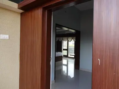 a hallway with a door leading to a bedroom at Bandipur Wildlife Resort & Spa, Bandipur in Bandipūr