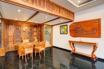a dining room with wooden walls and a table and chairs at Sterling Guruvayur in Guruvāyūr