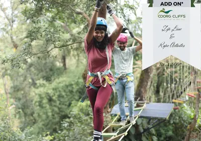 a man and a woman on a zip line in the jungle at Coorg Cliffs Resorts in Ammatti