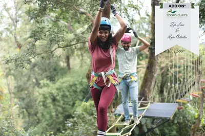 a man and a woman on a zip line at Coorg Cliffs Resorts in Ammatti